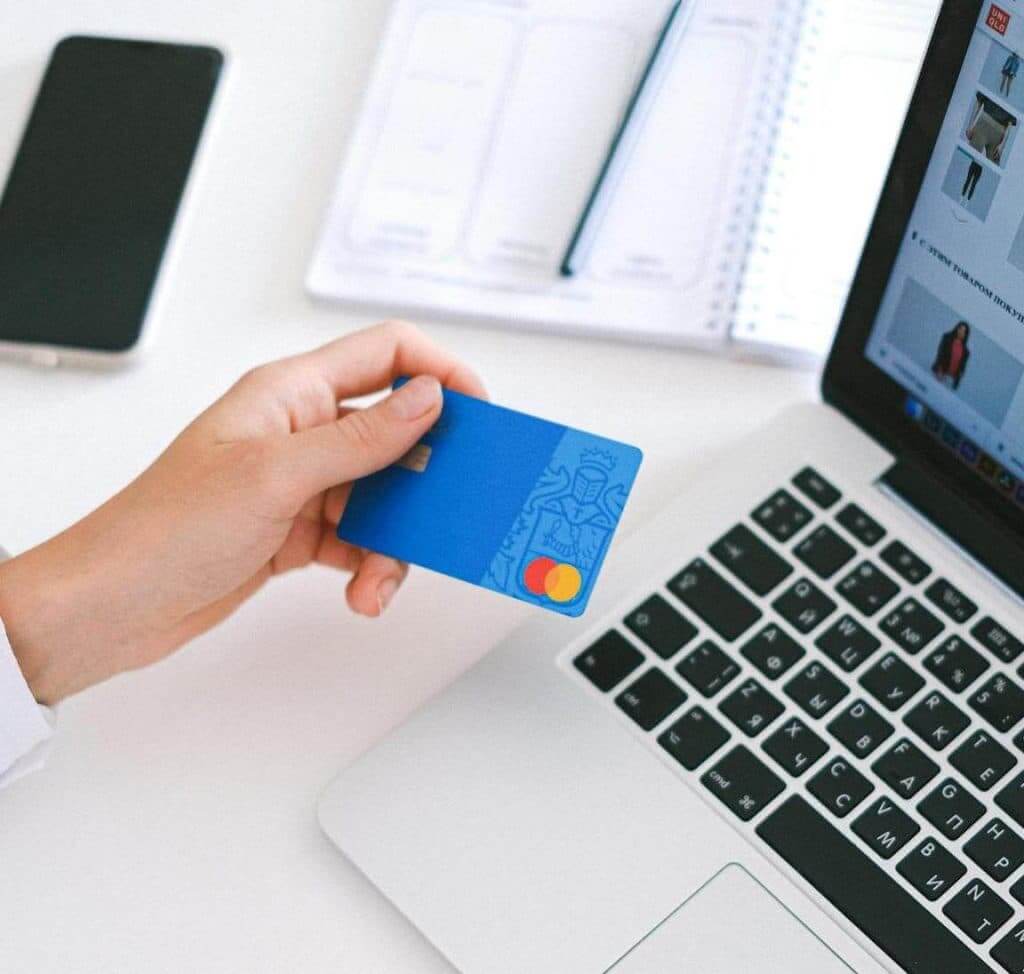 Close-up of a hand holding a credit card, symbolizing payment options